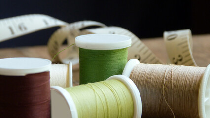 Rustic Sewing Equipment | Spools of Thread with a Measuring Tape in the Background