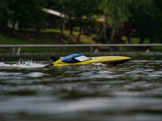 RC controlled jet boat model on lake. Active summer vacation for school child.