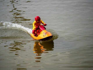 Fototapeta na wymiar RC controlled jet ski model on lake.