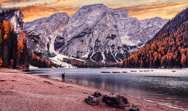 Wonderful sunrise view of Braies lake. Dramatic Unusual Scene. Colorful Sky over lago di Braies in Dolomites Alps. Awesome Alpine Highlands during sunset. Amazing nature Landscape at Autumn Day.