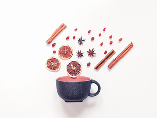 Autumn composition. Dried slices of lemon, star anise, cinnamon rolls and a black mug are on a white background. The concept of making homemade vitamin warming drinks. Top view. Flat lay.