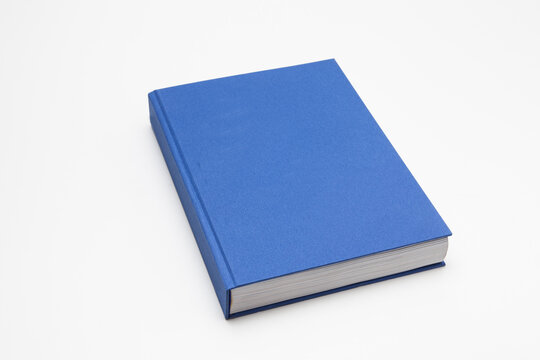 Blue book with no title standing on white background