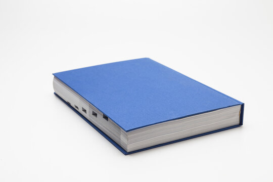 Blue book with no title standing on white background