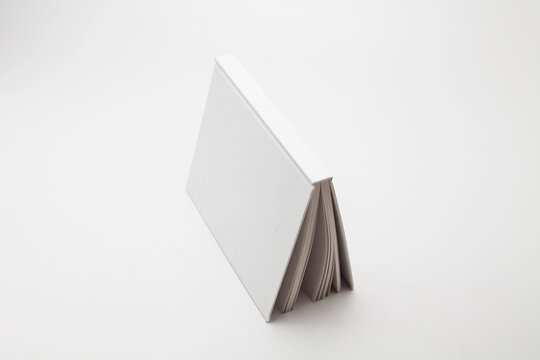 White book with no title standing on white background