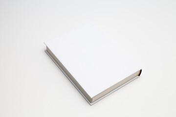 White book with no title standing on white background