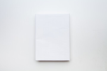 White book with no title standing on white background