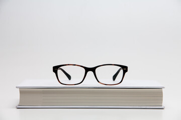 Books and glasses isolated on white background