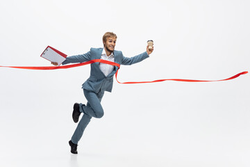 Career, success. Man in office clothes running, jogging on white background like professional athlete, sportsman. Unusual look for businessman in motion, action with ball. Sport, healthy lifestyle