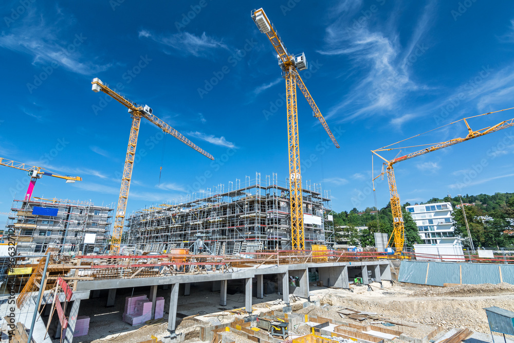 Wall mural large building site with foundations, cranes, scaffolding and partly finished buildings