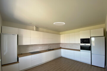 Stylish modern kitchen interior - cabinets sink refrigerator