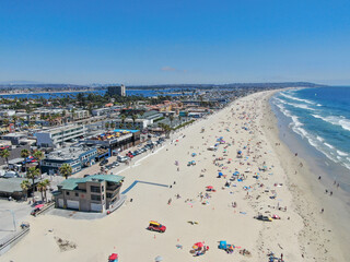 Aerial view of people at the beach during blue summer day. Pacific Beach in San Diego, California  - obrazy, fototapety, plakaty