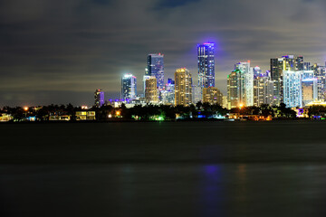 Miami, Florida, USA skyline on Biscayne Bay, city night backgrounds. Miami business district, lights and reflections of the city lights.