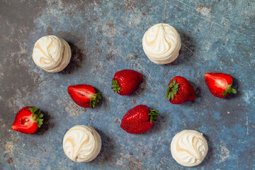 strawberries and marshmallows on a blue metal background..Healthy lifestyle and summer diet detox food concept. Copy space for text