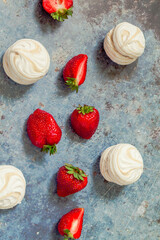 strawberries and marshmallows on a blue metal background..Healthy lifestyle and summer diet detox food concept. Copy space for text