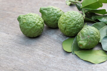 Group of fresh Bergamot fruit and bergamot leaves on wooden table background