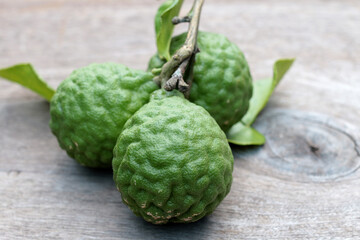 Group of fresh Bergamot fruit and bergamot leaves on wooden table background