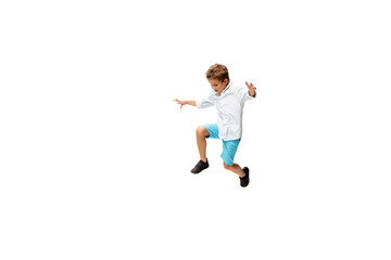 Happy child, little and emotional caucasian boy jumping and running isolated on white background. Looks happy, cheerful, sincere. Copyspace for ad. Childhood, education, happiness concept.