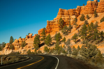 Utah Hwy 12 curves through Red Rock Canyon, near Bryce NP, Utah.  The rocks are eroded into the familiar pinnacles, spires, columns and hoodoos.