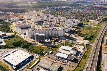 Construction of  house, multi-storey residential area in city. On sunset. Aerial view of Multistory houses. Real estate, high-rise buildings. Development Industry.