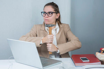 ragazza bionda vestita con una giacca beige è seduta nella sua postazione di lavoro tiene un...