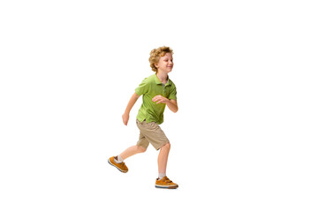 Fototapeta na wymiar Happy child, little and emotional caucasian boy jumping and running isolated on white background. Looks happy, cheerful, sincere. Copyspace for ad. Childhood, education, happiness concept.