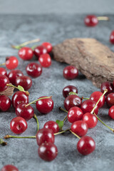Fototapeta na wymiar Red sour cherries on the concrete board