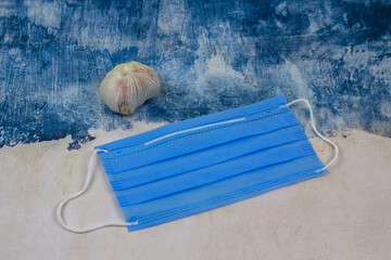 Blue face mask and garlic.