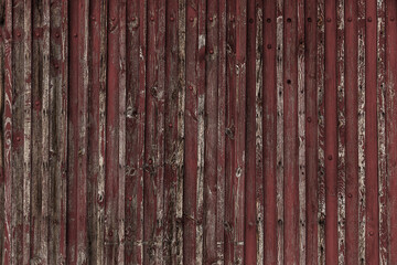Abstract Background of old painted wood. Wooden fence with traces of old cracked faded paint on the...