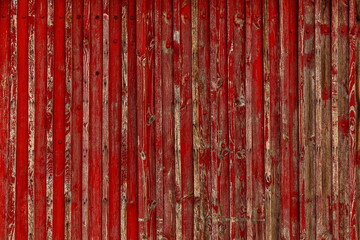 Fototapeta na wymiar Abstract Background of old painted wood. Wooden fence with traces of old cracked faded paint on the wood surface