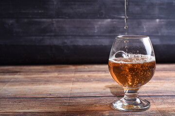 glass of beer on wooden table