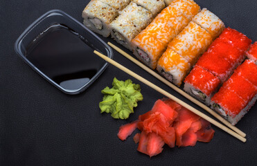 Japanese cuisine rice rolls with traditional chopsticks and wasabi with ginger,the view from the top