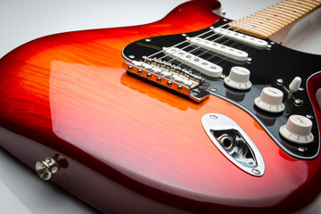 Electric guitar in sunburst cherry color.