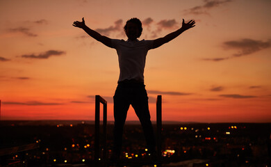 Anonymous guy during sundown on rooftop