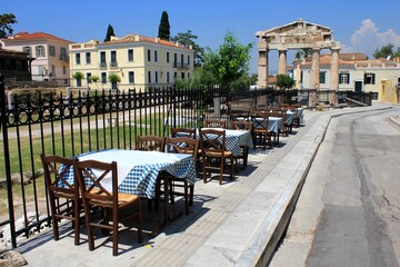 Fototapeta na wymiar Greece, Athens, July 16 2020 - Empty chairs and tables of a traditional restaurant in the touristic district of Plaka. 