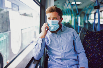 Men in bus wearing face mask