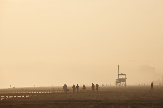 sand storm over Jesolo beach at sunset