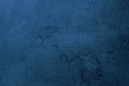 Abstract Grunge Decorative Rough Uneven Navy Blue Stucco Wall Background. Modern artwork. Art Texture.