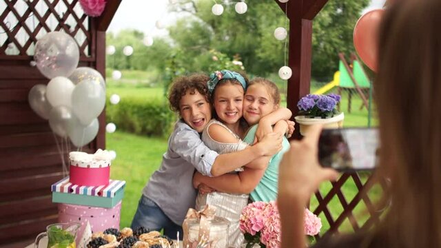 Parents take pictures of their children at a childrens party. Preadolescent kids at a birthday party, happy childhood, birthday photo shoot