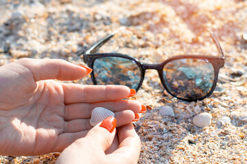 glasses from the sun next to female hands