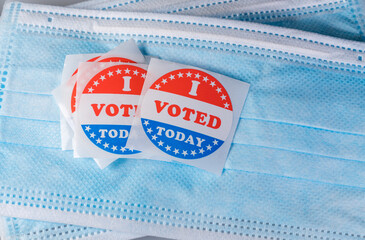 I Voted Today sticker on protective face mask for in person voting in the election in the USA...