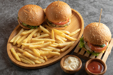 Burgers with french fries and sauces