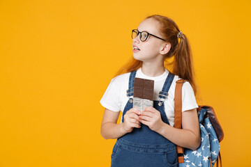 Young fun redhead school teen kid girl 12-13 years old in white t-shirt blue uniform eyeglasses...
