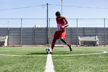 Mixed race male football player with prosthetic leg at a sports field