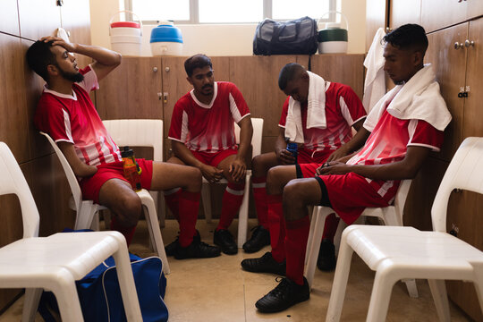 Multi ethnic group of male football in changing room