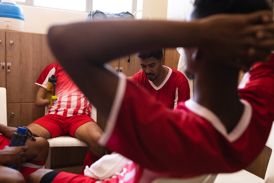 Multi ethnic group of male football in changing room