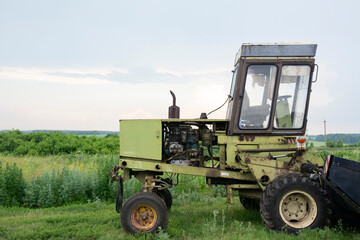 Old ,rusty, rural ,farm ,agricultural, dilapidated ,abandoned ,waste tractor.