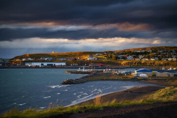 Naklejka na ściany i meble Husavik town in Northeast Iceland. City landscape at sunset