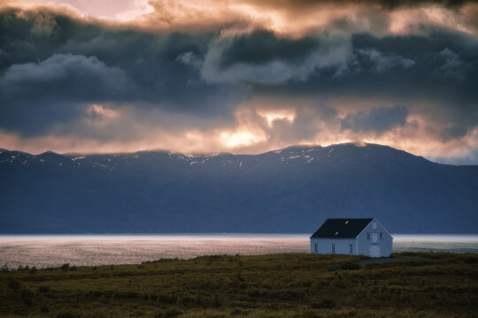 House on the coast in Northeast Iceland. Landscape at sunset