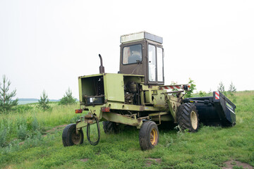 Obraz premium Old ,rusty, rural ,farm ,agricultural, dilapidated ,abandoned ,waste tractor.
