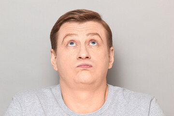 Naklejka premium Portrait of disappointed man sighing sadly, looking tired and bored